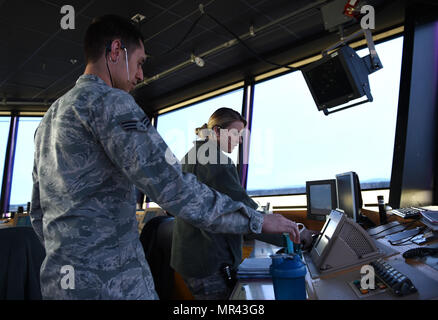 Senior Airman Nicholas Magliacane and Airman 1st Class Courtney Gomez, 62nd Operations Support Squadron Air Traffic Controllers, work to de-conflict air traffic at the McChord Field flight line on April 11, 2017, on Joint Base Lewis-McChord, Wash. The 62nd OSS tower at McChord responded quickly to prevent an aircraft incident April 11, 2017, on the McChord runway, when an U.S. Navy P-3 Orion seemingly lost all radio communications with them. (Air Force Photo/ Staff Sgt. Naomi Shipley) Stock Photo