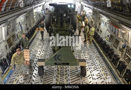 Airmen and Soldiers load a Rough Terrain Container Handler onto a C-17 ...