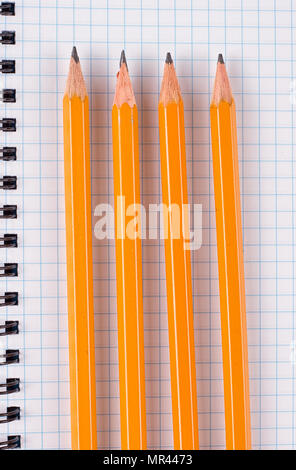 Top view of office supplies of dark table. Opened notepad and colorful pencils on black background Stock Photo
