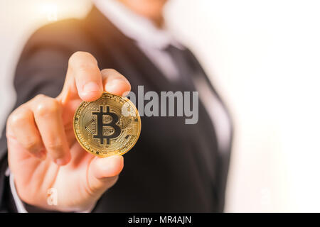 cryptocurrency coins - Bitcoin, Ethereum, Litecoin, Ripple. Women hold the cryptocurrency coin on hand. Physical bitcoins gold and silver coins Stock Photo