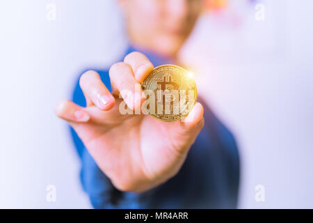 cryptocurrency coins - Bitcoin, Ethereum, Litecoin, Ripple. Women hold the cryptocurrency coin on hand. Physical bitcoins gold and silver coins Stock Photo