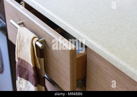 A pull-out kitchen box in the kitchen and a brown towel Stock Photo