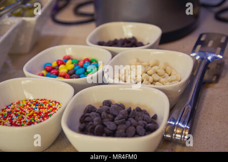 Colorful candy sprinkles and chocolate chips in ceramic bowl Stock Photo