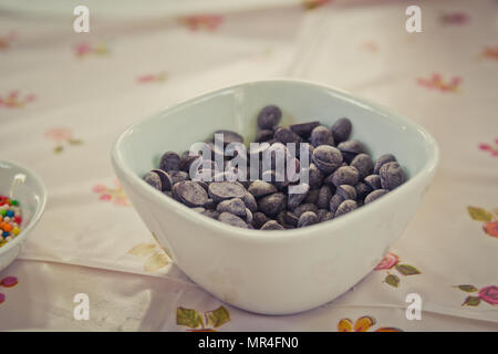 Colorful candy sprinkles and chocolate chips in ceramic bowl Stock Photo