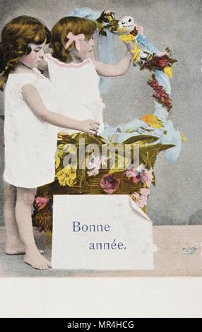 French new year postcard depicting two young girls, with a basket of flowers 1900 Stock Photo