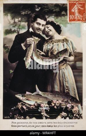 Vintage, French, postcard  depicting a couple holding fish. 1900 Stock Photo