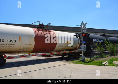 Rail tanker cars carrying corrosive hydrocloric acid pass through a Chicago south side neighborhood. Stock Photo