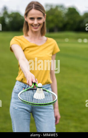 close-up view of woman holding badminton racquet with shuttlecock on the top Stock Photo