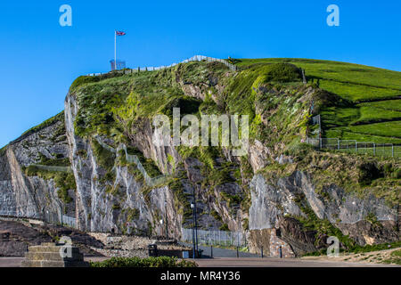 Capstone hill in Ilfracombe, Devon on a sunny afternoon with the union jack flag flying proudly at the top Stock Photo