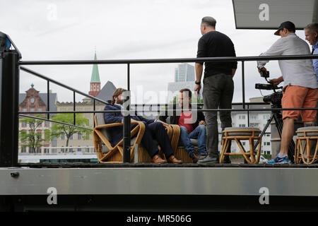 Actors Antoine Monot, Jr. (left) and  Wanja Mues (2nd right) give a TV interview on the terrace of the upper level of the houseboat that is owned by Mues' character Leo in the TV show. 4 new episodes of the relaunch of the long running TV series 'Ein Fall fuer zwei’ (A case for two) are being filmed in Frankfurt for the German state TV broadcaster ZDF (Zweites Deutsches Fernsehen). It stars Antoine Monot, Jr. as defence attorney Benjamin ‘Benni’ Hornberg and Wanja Mues as private investigator Leo Oswald. The episodes are directed by Thomas Nennstiel. The episodes are set to air in October. (Ph Stock Photo