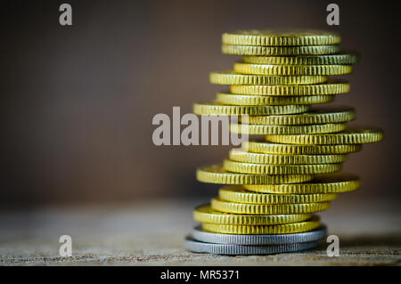 Coins stacked on each other in different positions. Money saving concept. Stock Photo