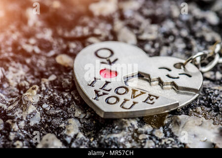 Abstrack Love key chain on dark background. Love, person and valentine concept. Stock Photo