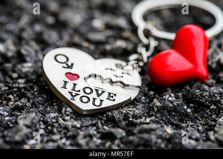 Abstrack red heart and Love key chain on dark background. Love, person and valentine concept. Stock Photo