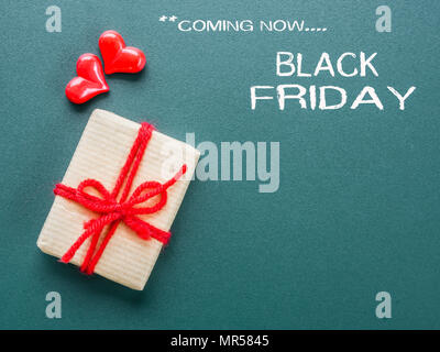Black Friday word on a board with red hearts and gift box. Stock Photo