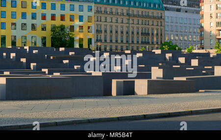 Photograph of the Memorial to the Murdered Jews of Europe (Holocaust Memorial), in Berlin. Dedicated to the Jewish victims of the Holocaust, designed by architect Peter Eisenman and engineer Buro Happold. It consists of concrete slabs or 'stelae', arranged in a grid pattern on a sloping field. Dated 21st Century Stock Photo
