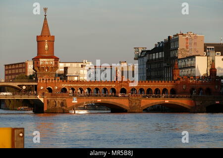 Photograph of the Oberbaum Bridge (Oberbaumbrücke) a double-deck bridge crossing Berlin's River Spree, considered one of the city's landmarks. It links Friedrichshain and Kreuzberg, former boroughs that were divided by the Berlin Wall, and has become an important symbol of Berlin’s unity. Dated 21st Century Stock Photo