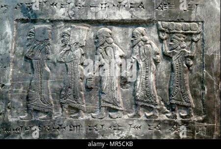 Detail from the Black Obelisk, of Shalmaneser III. A black limestone Assyrian sculpture with scenes in bas-relief and inscriptions. It comes from Nimrud (ancient Kalhu), in northern Iraq, and commemorates the deeds of King Shalmaneser III (reigned 858-824 BC). Stock Photo