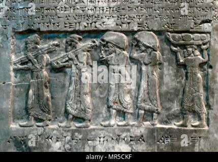 Detail from the Black Obelisk, of Shalmaneser III. A black limestone Assyrian sculpture with scenes in bas-relief and inscriptions. It comes from Nimrud (ancient Kalhu), in northern Iraq, and commemorates the deeds of King Shalmaneser III (reigned 858-824 BC). Stock Photo