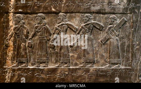 Detail from the Black Obelisk, of Shalmaneser III. A black limestone Assyrian sculpture with scenes in bas-relief and inscriptions. It comes from Nimrud (ancient Kalhu), in northern Iraq, and commemorates the deeds of King Shalmaneser III (reigned 858-824 BC). Stock Photo