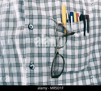 Pens and glasses in shirt pocket Stock Photo