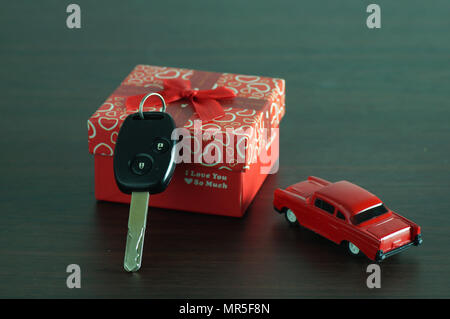 key of car in gift box on wood table Stock Photo
