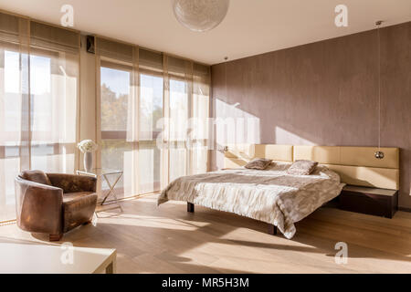 Spacious bedroom interior with marital bed Stock Photo