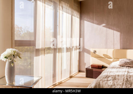 Modern designed bedroom with wide window Stock Photo