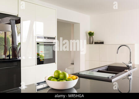 Futuristic high gloss kitchen in white with black worktop Stock Photo