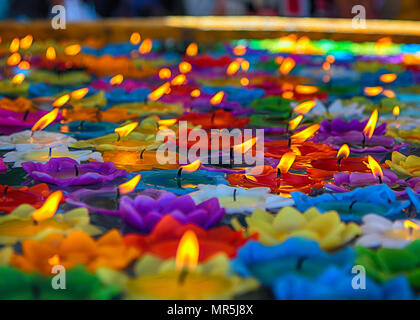 burning candles at a Buddhist temple in Thailand Stock Photo