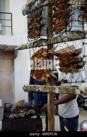 Food vendor cooks and sells Barbecue Grill fish at the street market in Banda Aceh City Stock Photo