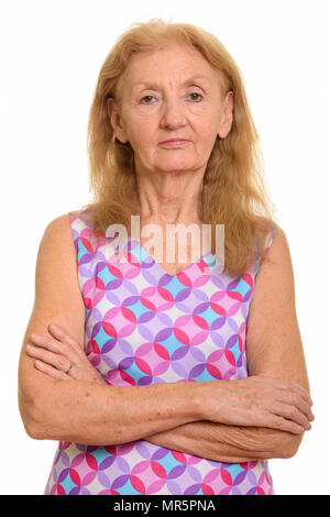 Studio shot of senior woman with arms crossed Stock Photo