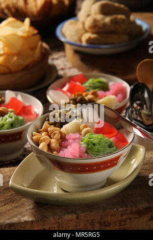 Wedang Angsle. Javanese hot dessert of ginger and coconut soup with various toppings. Accompanied with local, traditional snacks from the area. Stock Photo