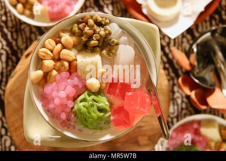 Wedang Angsle. Javanese hot dessert of ginger and coconut soup with various toppings. Stock Photo