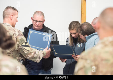 U.S. Army Maj. Gen. John C. Thomson III, 1st Cavalry Division Commanding General, presents a photo to USO entertainers at Bagram Airfield, Afghanistan, March 30, 2017. U.S. Air Force Gen. Paul J. Selva, Vice Chairman of the Joint Chiefs of Staff, along with USO entertainers, visited service members who are stationed outside the continental U.S. at various locations across the globe.  This year’s entertainers included country musician Craig Morgan, mixed-martial artist Dominick Cruz, chef Robert Irvine, U.S. Olympic Swimmer Katie Meili, and mentalist Jim Karol. (DoD Photo by U.S. Army Sgt. Jame Stock Photo