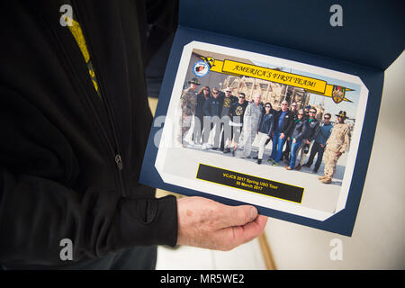 Mentalist Jim Karol holds a photo presented by U.S. Army Maj. Gen. John C. Thomson III, 1st Cavalry Division Commanding General, at Bagram Airfield, Afghanistan, March 30, 2017. U.S. Air Force Gen. Paul J. Selva, Vice Chairman of the Joint Chiefs of Staff, along with USO entertainers, visited service members who are stationed outside the continental U.S. at various locations across the globe.  This year’s entertainers included country musician Craig Morgan, mixed-martial artist Dominick Cruz, chef Robert Irvine, U.S. Olympic Swimmer Katie Meili, and Karol. (DoD Photo by U.S. Army Sgt. James K. Stock Photo