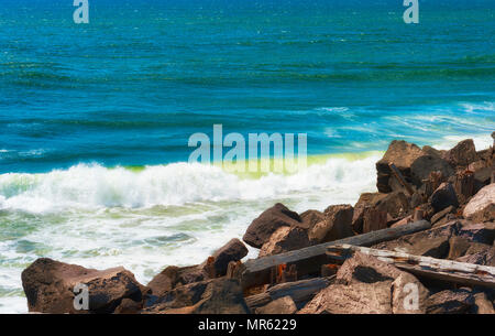 Waves run along side the south jetty rock wall where the Columbia River and the Pacific Ocean meet. Stock Photo