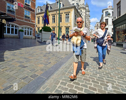 Older couple looking at a map while walking in Brussels, Belgium. Stock Photo