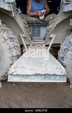 A Ukrainian soldier from 1st Airmobile Battalion, 79th Air Assault Brigade cleans weapons parts inside his armored personnel carrier after taking part in a gunnery range at the Yavoriv Combat Training Center, on the International Peacekeeping and Security Center, near Yavoriv, Ukraine, on May 16. (Photo by Sgt. Anthony Jones, 45th Infantry Brigade Combat Team) Stock Photo