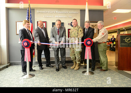 Lyman L. Hubbard Jr. (center), joined by (from left) Mayor James O. Langfelder, City of Springfield, Lee Hubbard, son of Lyman Hubbard Sr., Maj. Gen. Richard J. Hayes, Adjutant General, State of Illinois, Brian McFadden, Sangamon County Administrator, and Mr. Dan O'Brien, Executive Director, Abraham Lincoln Council, Boy Scouts of America, cuts the ribbon on the Lyman L. Hubbard Sr. memorial at Abraham Lincoln Capital Airport. Stock Photo