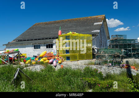 Lobster traps and buoys piled up in the seaside village of Peggy's Cove, Nova Scotia, Canada. Stock Photo