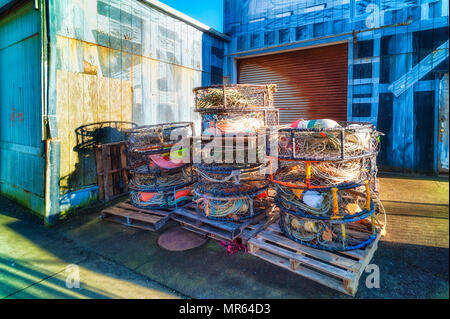 Crab pots sit outside a pier warehouse in Newport, on the Oregon Coast Stock Photo