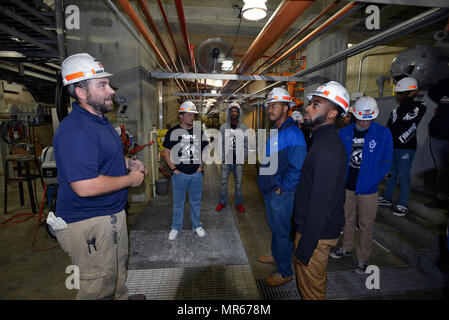 Old Hickory Dam Hydropower Plant is a hydroelectric facility operated by the U.S. Army Corps of Engineers Nashville District in Hendersonville, Tennessee. The archival image documents a hydropower operator trainee briefing high school and college students in the control room on gravity-fed water flow through generating units on May 4, 2017, as part of a STEM outreach effort. Stock Photo