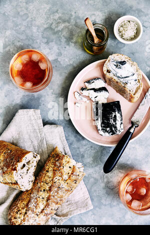 Ash coated goat cheese and rose wine. Stock Photo