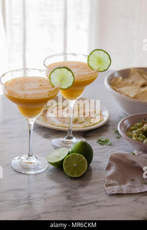 Mango Margarita with dips on a table Stock Photo