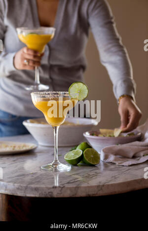 Mango Margarita with dips on a table Stock Photo