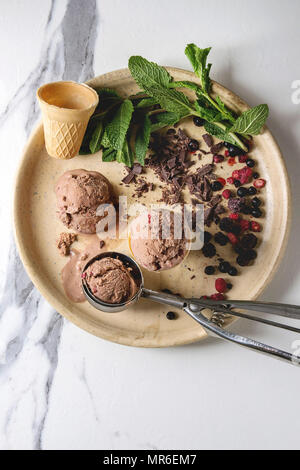 https://l450v.alamy.com/450v/mr6em7/homemade-chocolate-raspberry-ice-cream-balls-served-with-frozen-berries-mint-chopped-dark-chocolate-and-metal-spoon-in-ceramic-plate-over-white-marb-mr6em7.jpg