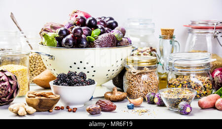 Balanced diet, cooking, vegetarian, raw and clean eating concept - close up of fresh organic fruits and vegetables, grains, legumes and nuts on concre Stock Photo