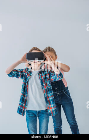 casual kids using virtual reality headset together Stock Photo