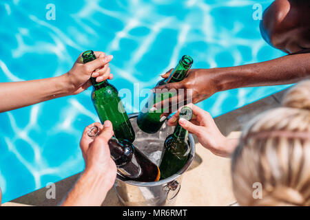 https://l450v.alamy.com/450v/mr6rmt/cropped-image-of-human-hands-taking-cold-beer-from-ice-bucket-standing-on-edge-of-swimming-pool-mr6rmt.jpg