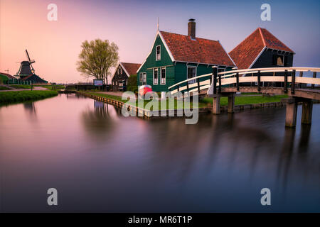 Sunset over historic houses and windmills of Zaanse Schans in the Netherlands Stock Photo